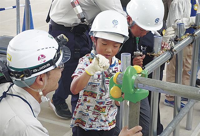 クランプ取り付け作業を体験する小学生